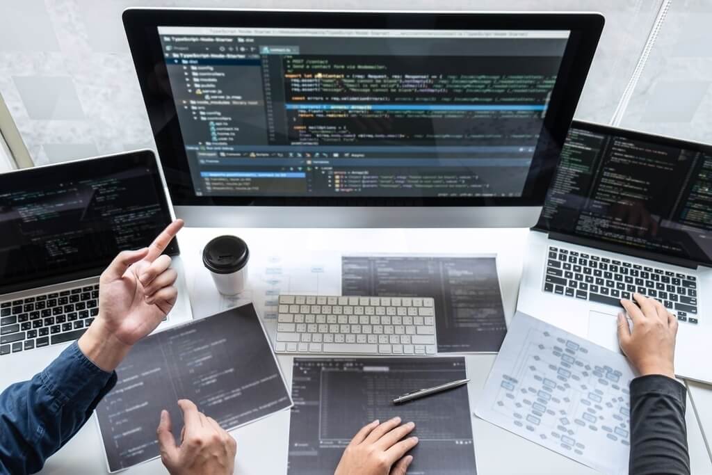 professional software development team collaborating on software code