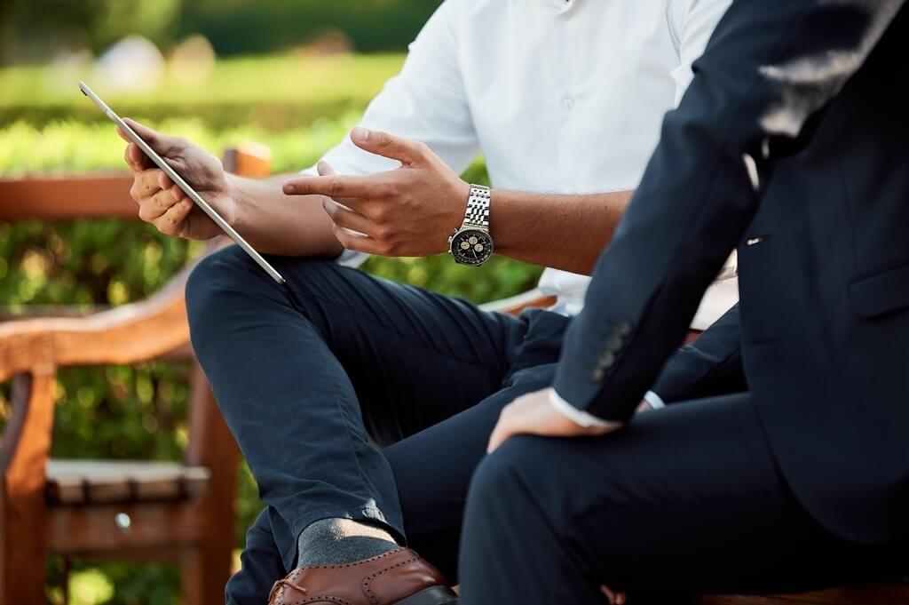 business consultant showing data on table device