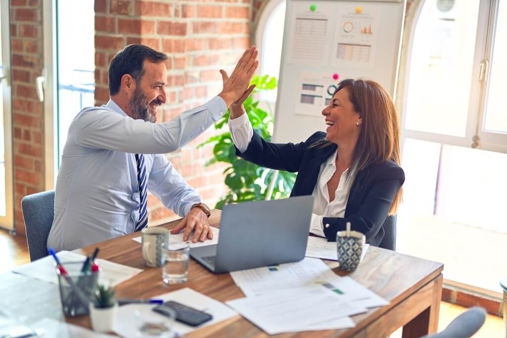 business man and woman high five